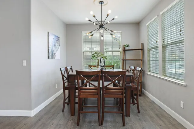 a view of living room with kitchen island furniture and a flat screen tv