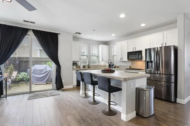 a kitchen with a refrigerator cabinets and sink