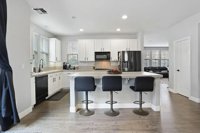 a kitchen with a stove a sink and a refrigerator