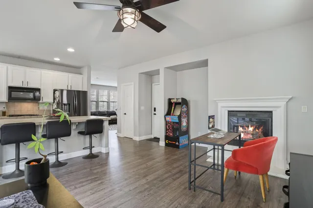 a view of a livingroom with workspace and a window
