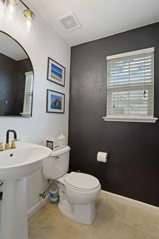 a living room with furniture and potted plants