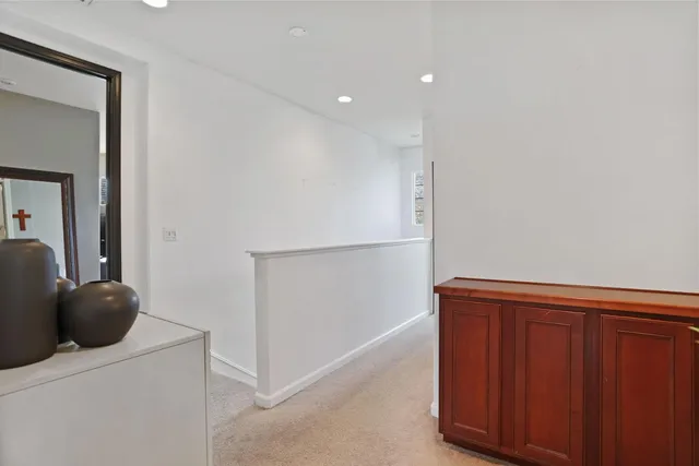 a bedroom with a bed a table and windows