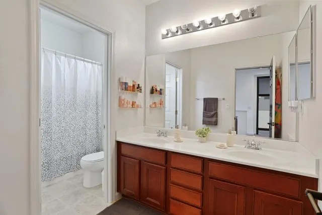 a white toilet sitting next to a shower curtain