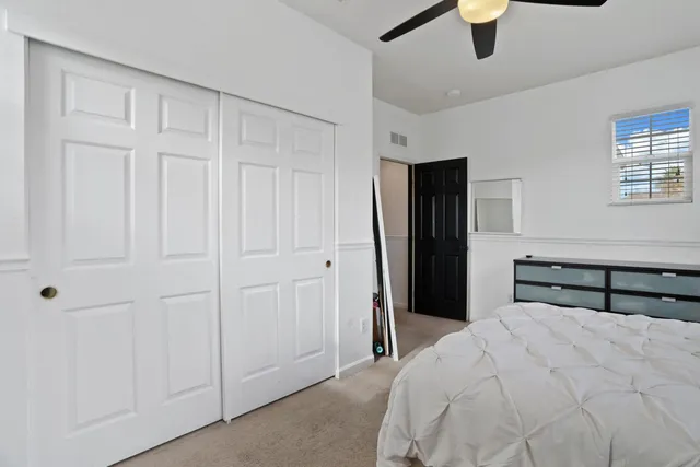 a bedroom with a bed couch and a window