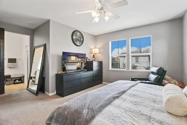 a bed room with a bed and a chair