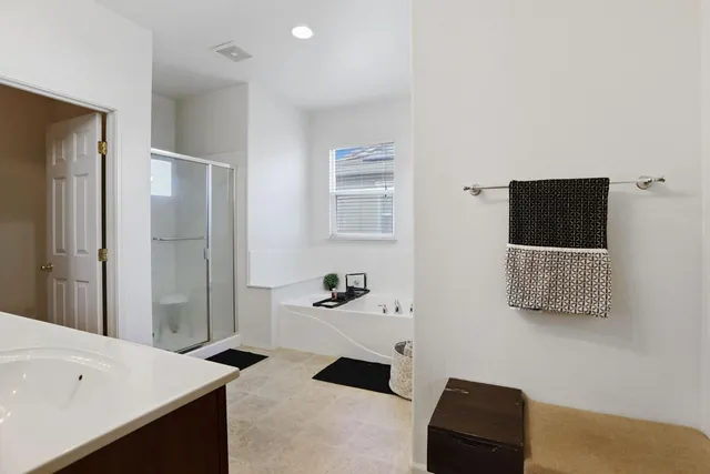 a bathroom with a granite countertop sink a toilet and a mirror