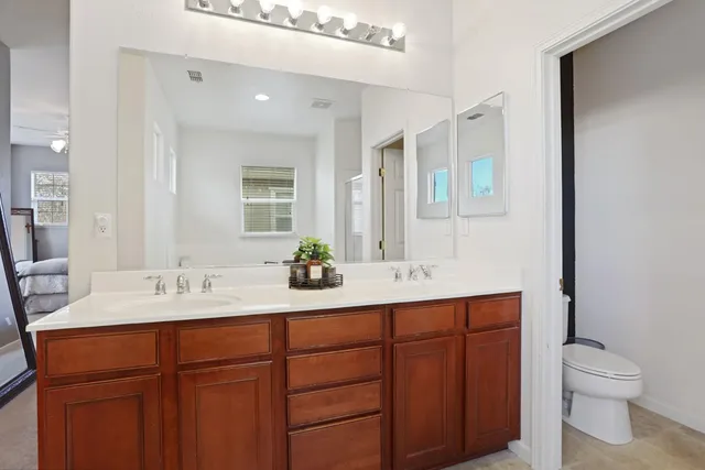 a bathroom with a double vanity sink and mirror