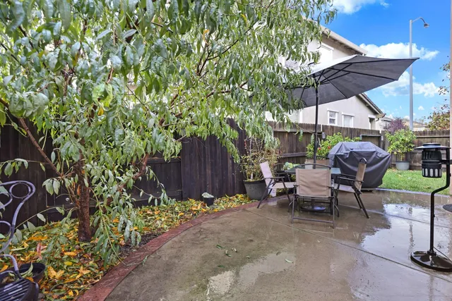 a patio with a patio table and chairs