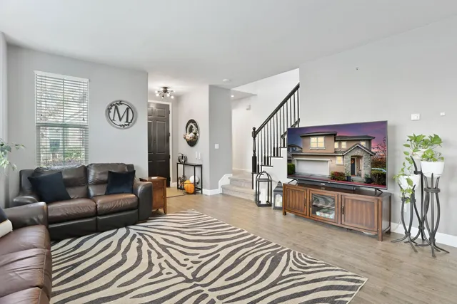 a view of a dining room with furniture wooden floor and chandelier