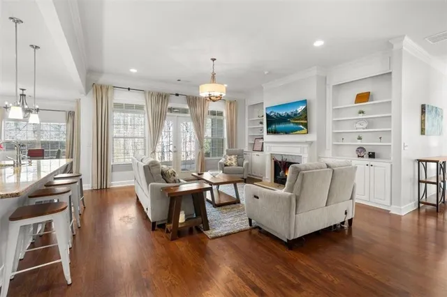 a living room with furniture a fireplace and a flat screen tv