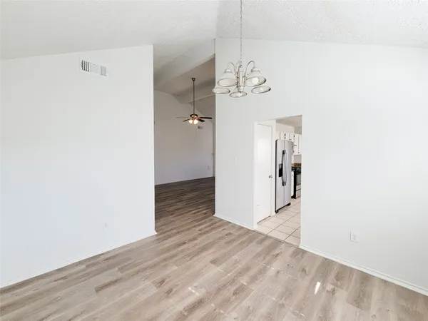 a kitchen with granite countertop a sink window and cabinets