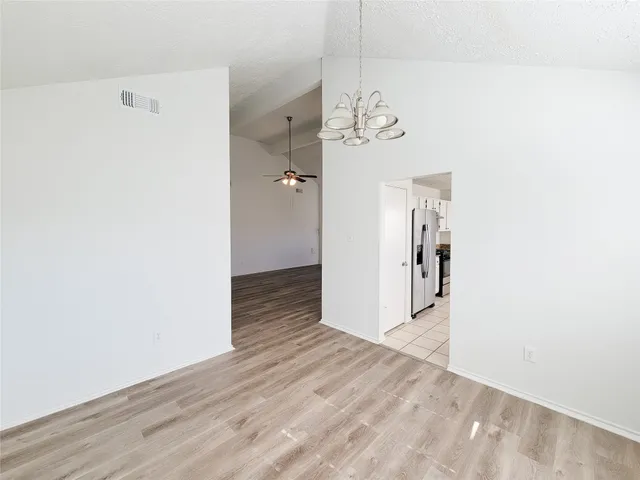 a kitchen with granite countertop a sink window and cabinets