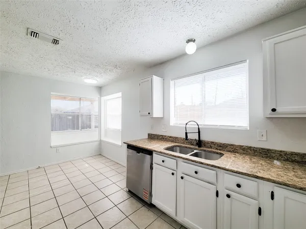 a kitchen with cabinets a stove a sink and a counter top space