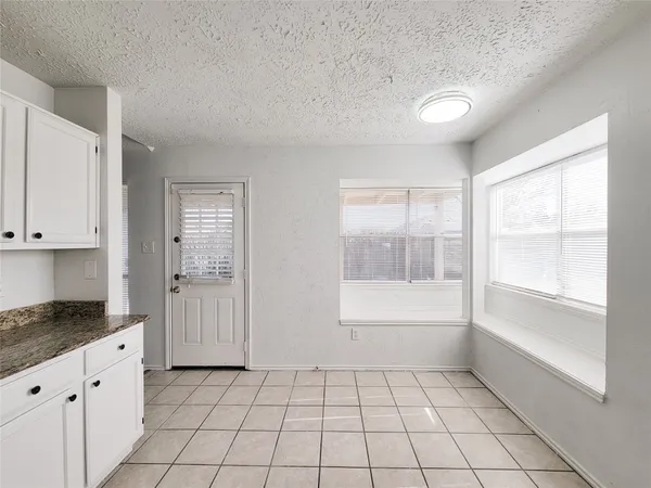 a large kitchen with a stove a sink dishwasher and a refrigerator