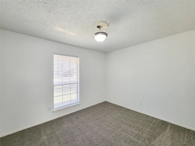 a bathroom with a granite countertop sink a mirror and a bathtub