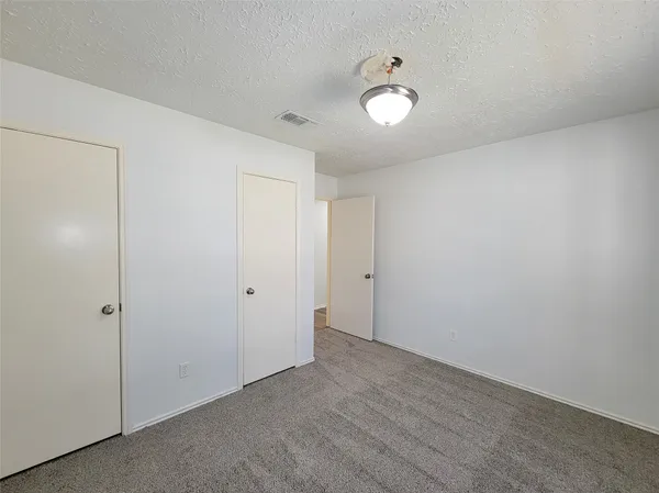 a bathroom with a granite countertop sink a toilet and bathtub