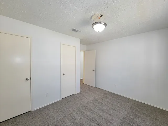 a bathroom with a granite countertop sink a toilet and bathtub