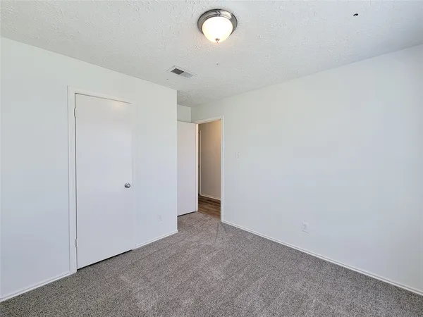 a bathroom with a granite countertop sink a toilet and bathtub