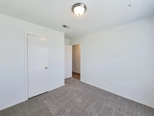 a bathroom with a granite countertop sink a toilet and bathtub