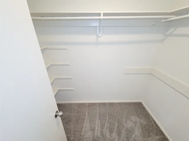 a view of empty room with ceiling fan