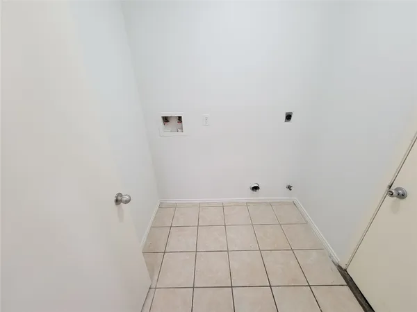 a view of a backyard with large trees plants and wooden fence