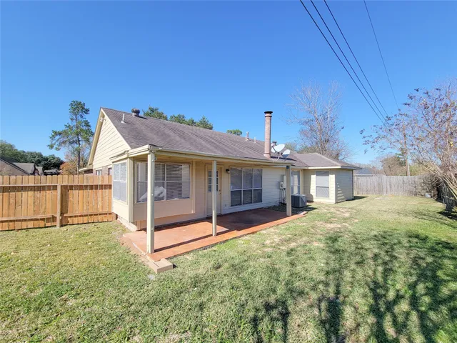 a view of a backyard with a large tree