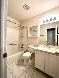 a bathroom with a sink toilet a mirror and shower