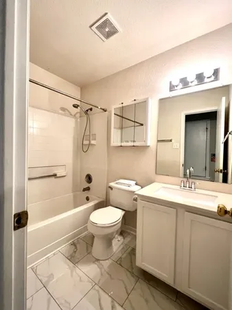 a bathroom with a sink toilet a mirror and shower