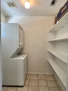 a utility room with cabinets washer and dryer