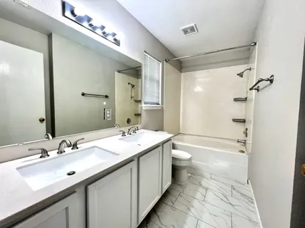 a bathroom with a double vanity sink mirror double and shower