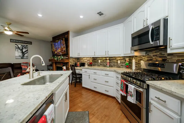 a living room with furniture a fireplace and a large window