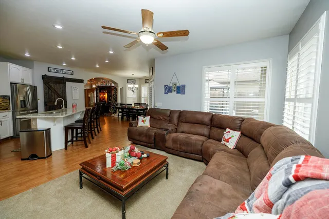 a living room with furniture wooden floor and chandelier