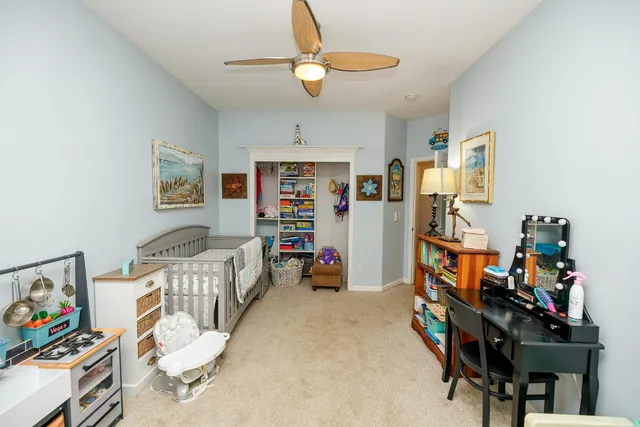 a bedroom with furniture and large windows