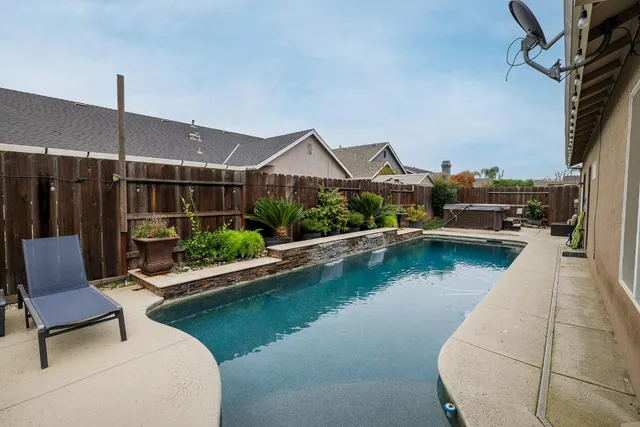 a view of a balcony with wooden floor and potted plants