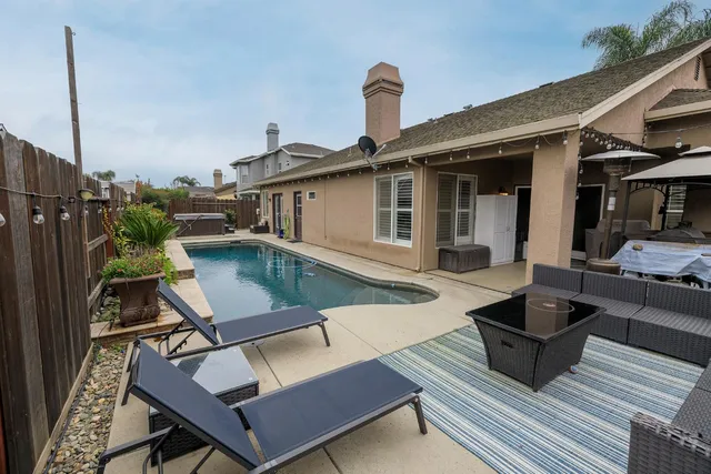 a view of a patio with a table and chairs