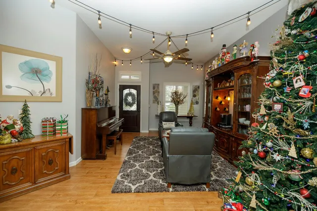 a living room with furniture and a chandelier