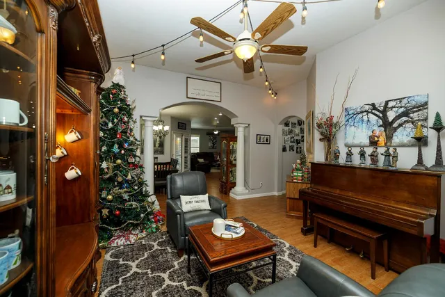a living room with furniture and a chandelier