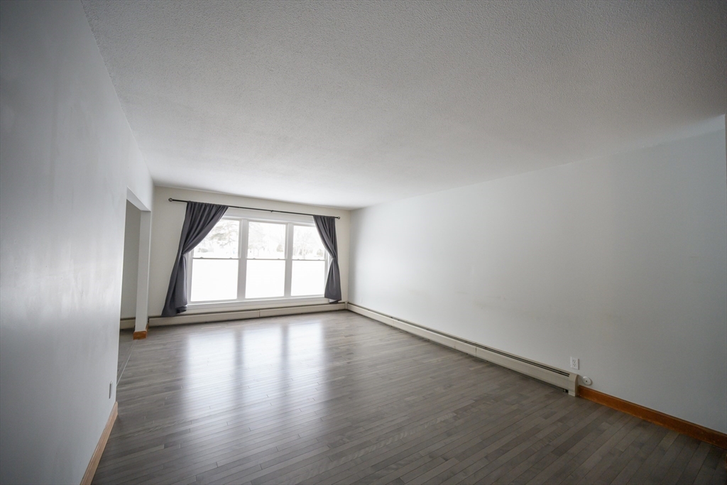 89 Potwine Lane Amherst, MA 01002 - Photo 12 of 41 an empty room with wooden floor and windows