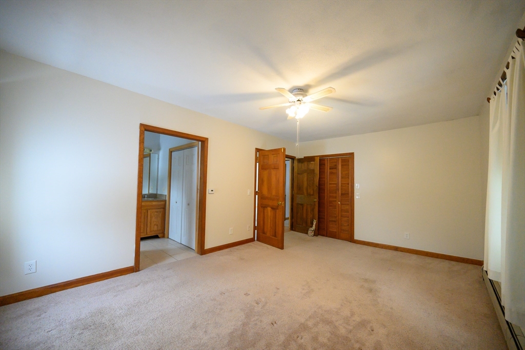 89 Potwine Lane Amherst, MA 01002 - Photo 13 of 41 an empty room with closet and chandelier fan
