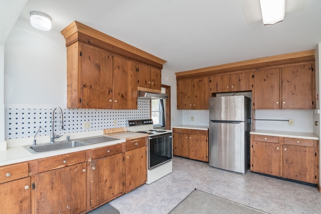 89 Potwine Lane Amherst, MA 01002 - Photo 16 of 37 a kitchen with stainless steel appliances granite countertop a refrigerator stove and sink