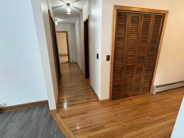 a view of hallway with wooden floor