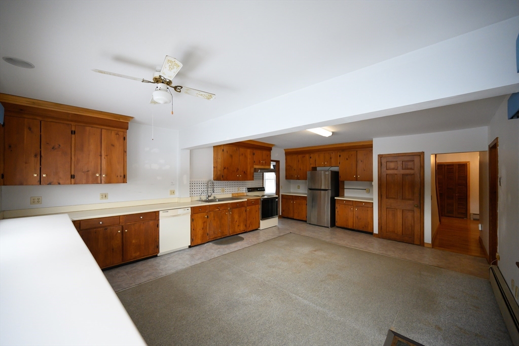89 Potwine Lane Amherst, MA 01002 - Photo 19 of 41 a large kitchen with a large counter top cabinets and stainless steel appliances