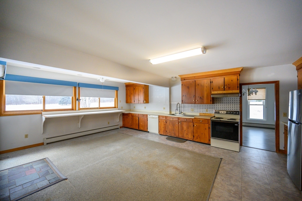 89 Potwine Lane Amherst, MA 01002 - Photo 20 of 41 a kitchen with stainless steel appliances kitchen island granite countertop a refrigerator and stove