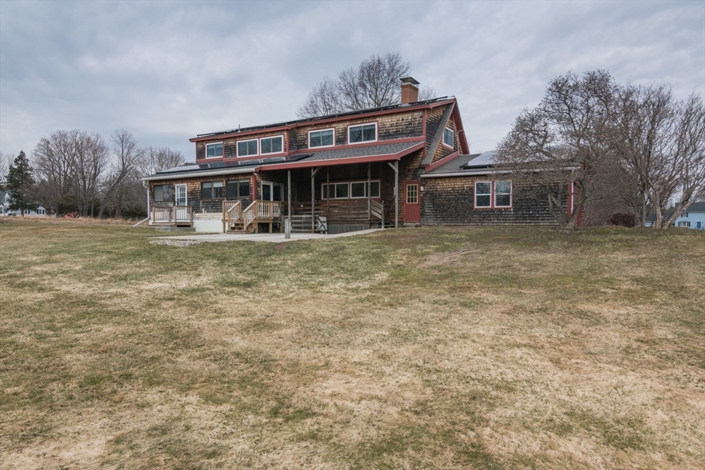 89 Potwine Lane Amherst, MA 01002 - Photo 2 of 37 a view of a house with a large window and a yard
