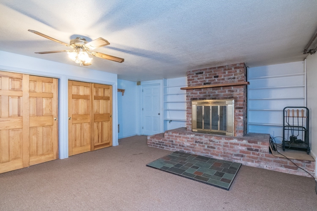 89 Potwine Lane Amherst, MA 01002 - Photo 26 of 37 a living room with furniture a fireplace and chandelier