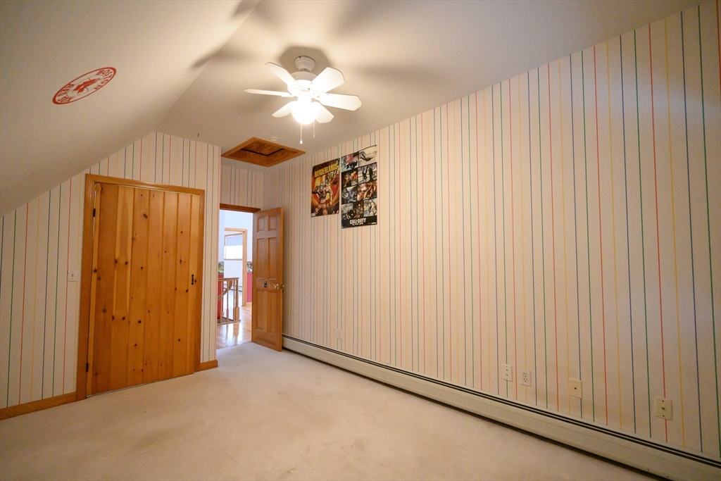 89 Potwine Lane Amherst, MA 01002 - Photo 29 of 41 an empty room with chandelier fan and windows
