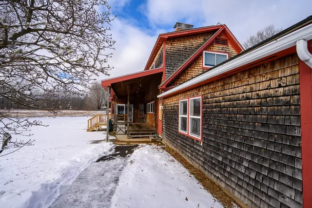 a view of house with backyard and trees