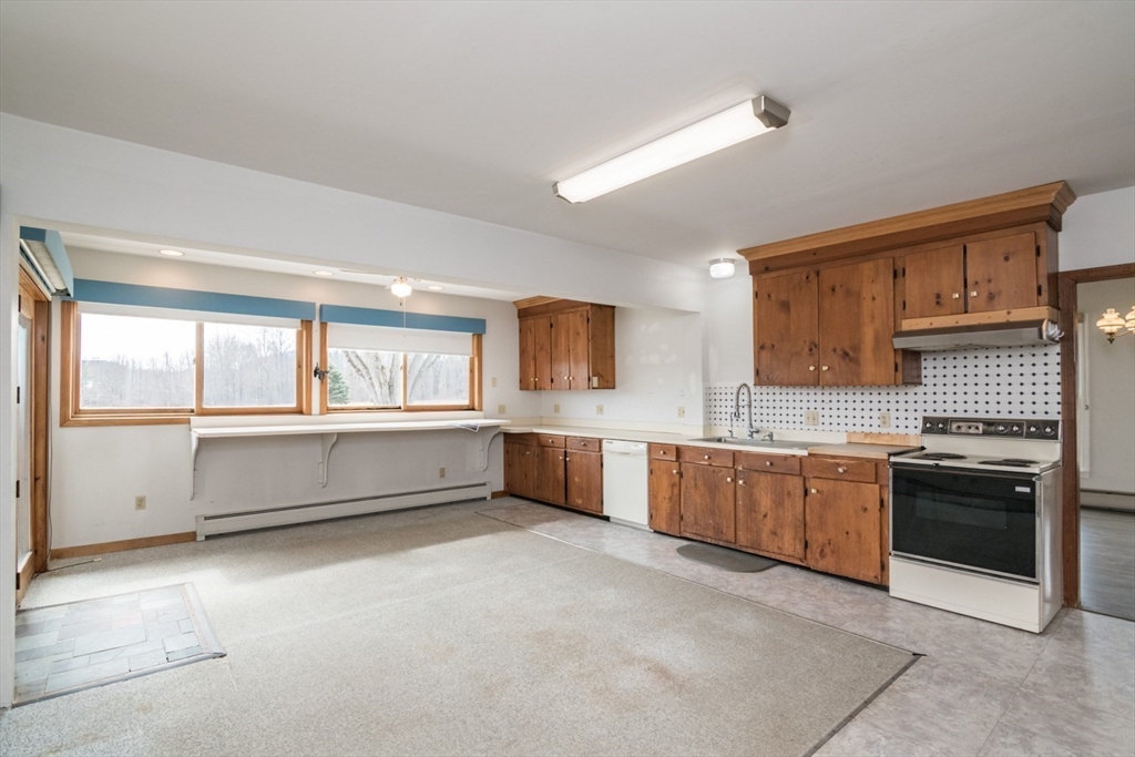 89 Potwine Lane Amherst, MA 01002 - Photo 7 of 37 a large kitchen with stainless steel appliances granite countertop a stove and a sink