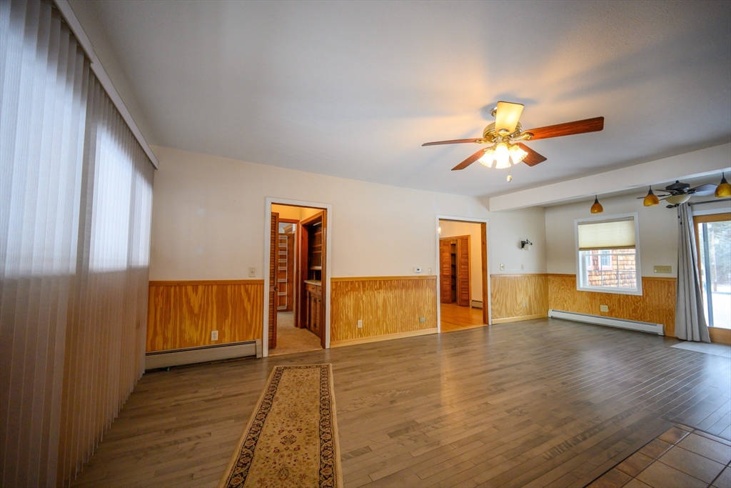 89 Potwine Lane Amherst, MA 01002 - Photo 8 of 41 a view of an empty room with window and wooden floor