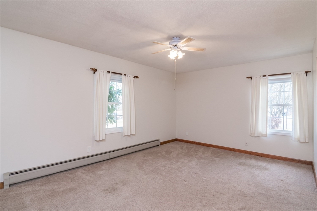 89 Potwine Lane Amherst, MA 01002 - Photo 10 of 37 an empty room with windows and fan